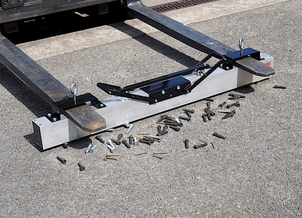 Fork Lift Mounted Magnetic Sweeper above some nails